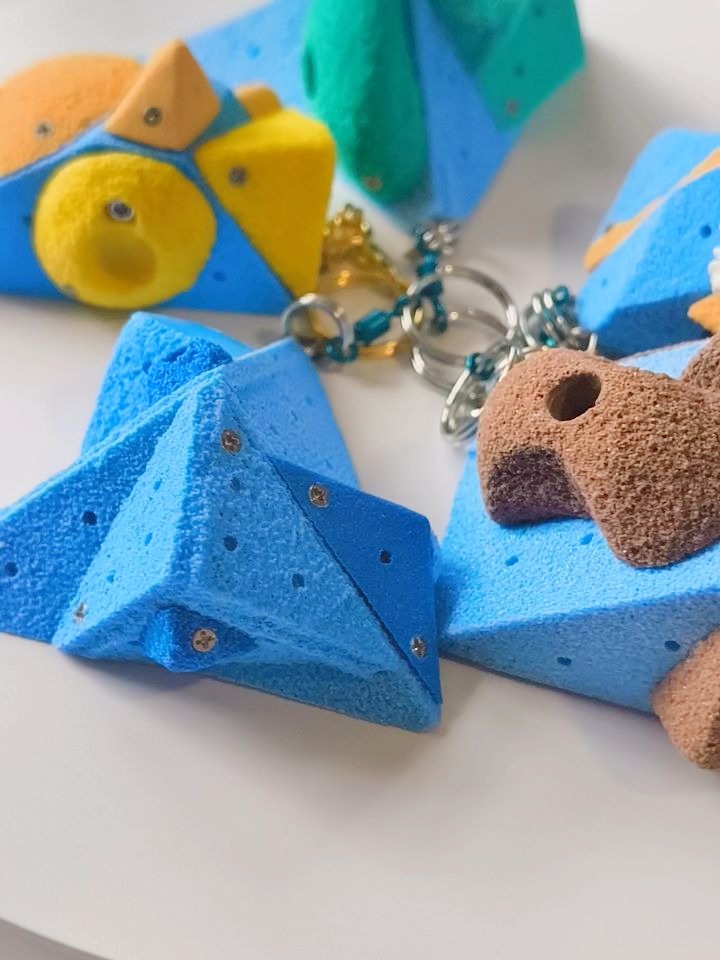 Blue miniature volume keychains with colourful holds and hardware